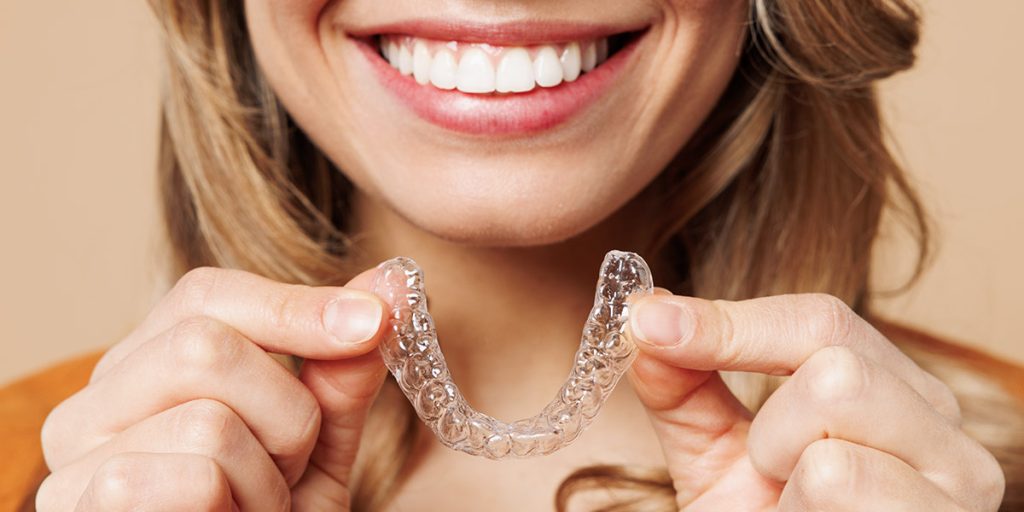 Woman smiling with invisalign and hidden braces London